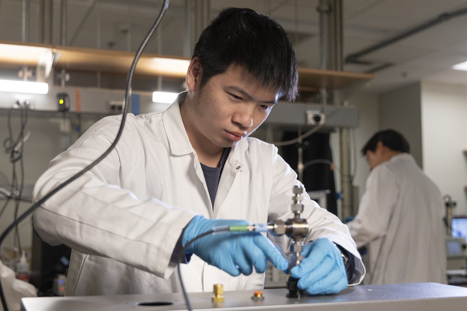 A laboratory member adjusting an aerosol measurement instrument