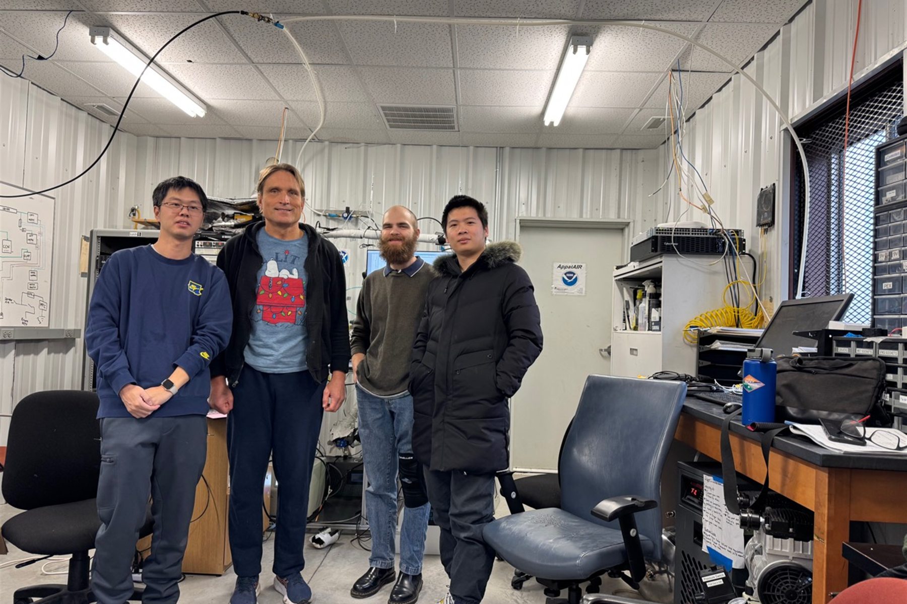 Researchers collaborating in an aerosol monitoring laboratory in Boone, North Carolina