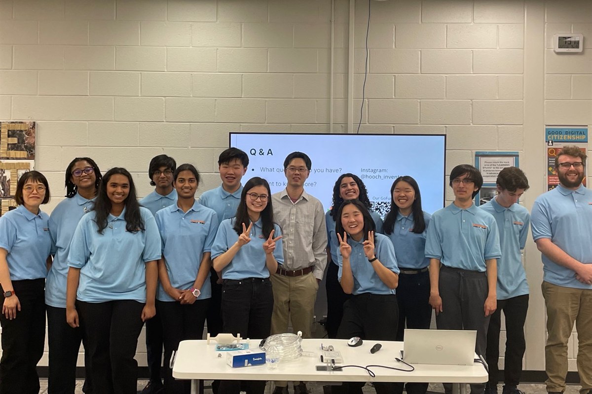 Pengfei Liu with students and educators at a research presentation at Chattahoochee High School